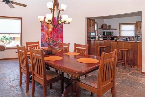 a kitchen and dining room with a wooden table and chairs at Seascape Villas in San Pedro