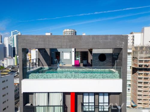 a building with a swimming pool on top of it at Porto Privilege by VLV Stays in Salvador