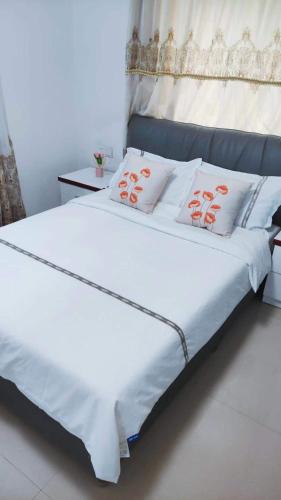 a bed with two white pillows on top of it at Mushe Inn 