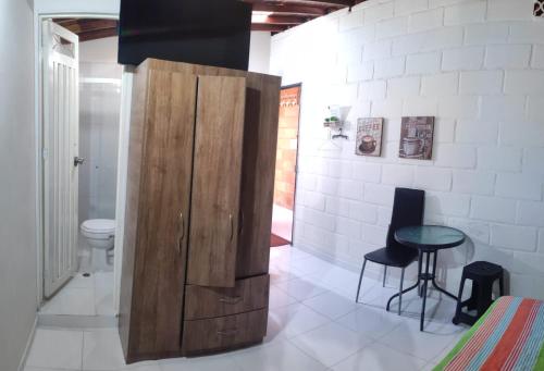 a large wooden cabinet in a room with a table at Gaia in Medellín