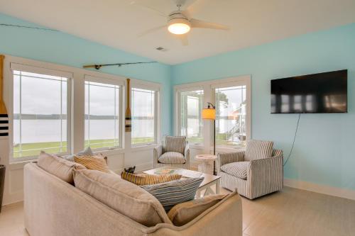 a living room with two couches and a tv at Lakefront Home with Hot Tub and Dock in Cross Hill! in Cross Hill