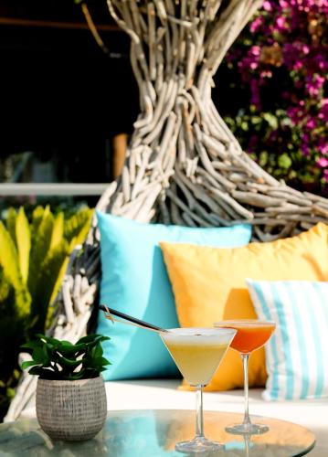 two martini glasses sitting on top of a table at Rammos Managed By Dedeman in Bodrum City