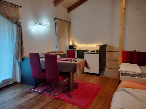 a room with a table and chairs and a kitchen at Agriturismo Casa de Colores in Moretta