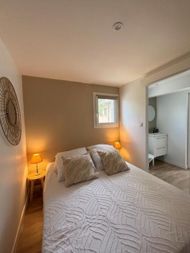a bedroom with a large white bed with two pillows at Maison in Lamonzie-Saint-Martin