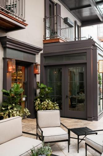 a patio with two chairs and a table at Hotel Richemont in Charleston