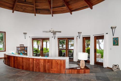 a large room with a bed and a ceiling at Seascape Villas in San Pedro