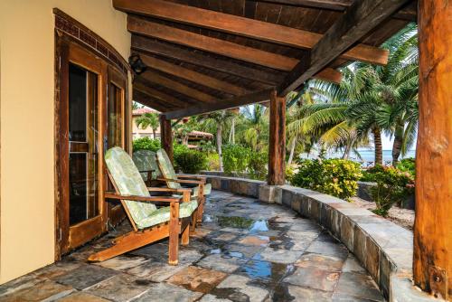 two chairs sitting on the porch of a house at Seascape Villas in San Pedro