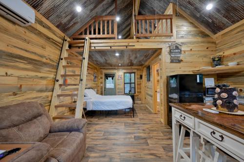 a living room with a bed and a bunk bed at Little Wolf Cabins and ATV Rentals in Mena