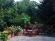a garden with a table and chairs and trees at Dimosthenis Karastamatis Rooms in Xorychti
