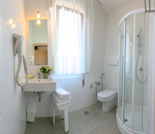 a bathroom with a sink and a shower and a toilet at Hotel Colonna in Lido di Jesolo