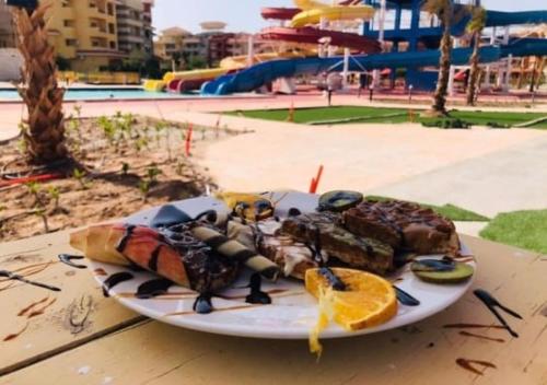 a plate of food sitting on top of a table at Elegant Apartments & Aquapark - B&B- FREE WI-FI-Sharm El Sheikh in Sharm El Sheikh