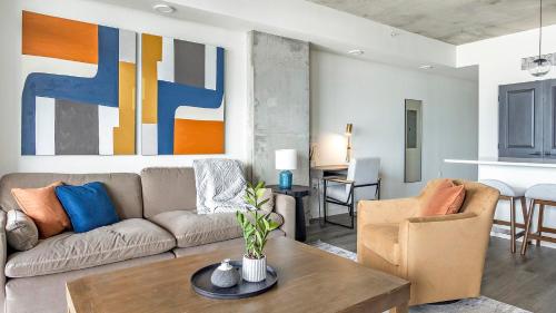 a living room with a couch and a table at Landing at Park and Main - 2 Bedrooms in Centra... in Feather Sound