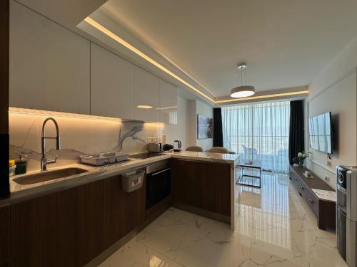 a large kitchen with a sink and a large window at Grand Sapphire One Bedroom Luxury Residences By MyGuest Cyprus in Iskele