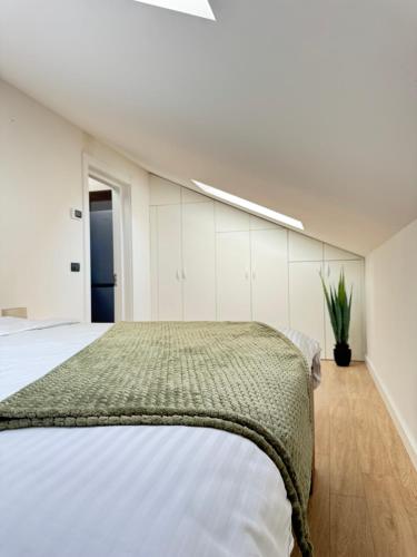 a bedroom with a large bed and white cabinets at Cara Grand Chalet in Braşov