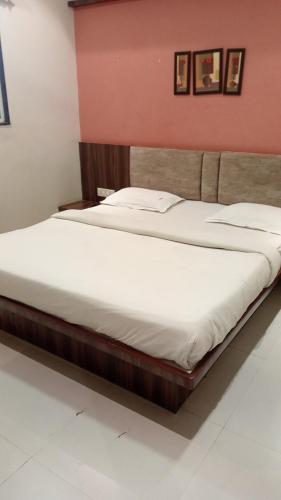 two beds sitting next to each other in a bedroom at Narayani lodge नारायणी लॉज in Kolhapur