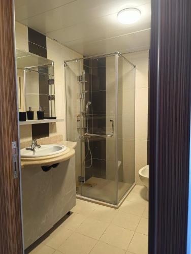 a bathroom with a shower and a sink at Royal Beach Resort in Hurghada