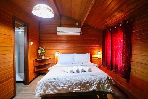 a bedroom with a bed with two pillows on it at בקתות ההוד in Kallanit