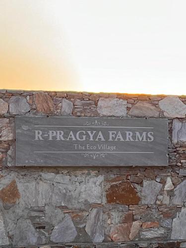 a sign on the wall of a building at R-Pragya Farmstay in Amarsar