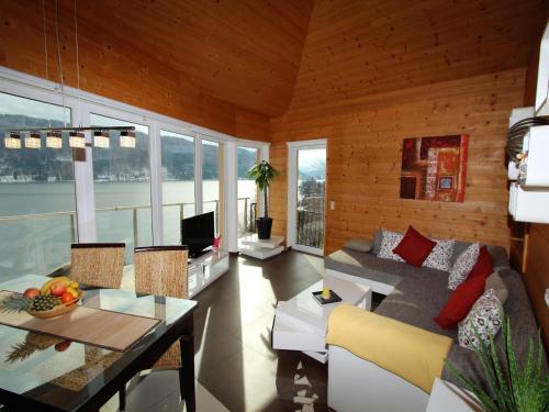a living room with a couch and a table at Apartment in Treffen near Gerlitzen Ski Slopes in Stöckelweingarten