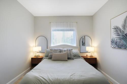 a bedroom with a large bed with two lamps at Shell Yeah 3 Story Condo On AMI in Holmes Beach