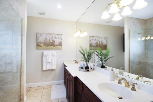 a bathroom with a sink and a mirror at Shell Yeah 3 Story Condo On AMI in Holmes Beach