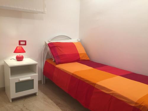 A bed or beds in a room at Baia Giardini Apartments