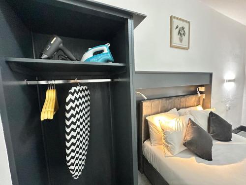 a bedroom with a bed with a black headboard at Magic Stay Rooms in London
