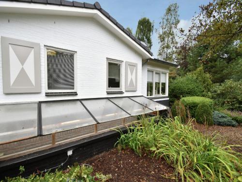 a white house with windows on the side of it at Holiday Home in Holten near Holterberg in Holten