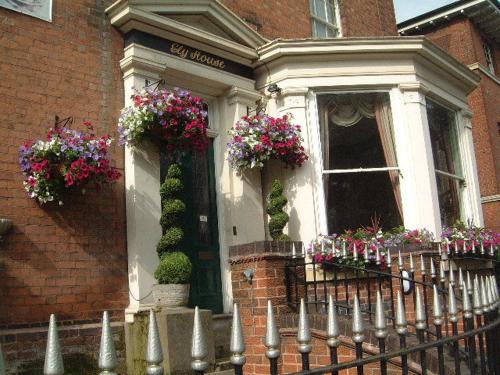 a house with flowers on the front of it at Ely House Hotel in Wolverhampton