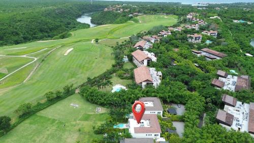 an aerial view of a golf course with a red marker at Exclusive Villa with Elevator in Casa de Campo in El Infiernito