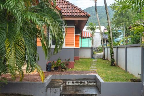 a house with a fountain in front of it at Areca Holiday Home 8, Bangtao Beach in Ban Thalat Choeng Thale