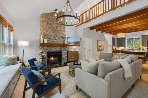 a living room with a couch and a fireplace at Bella and Dulce's Lakehouse in Union Pier