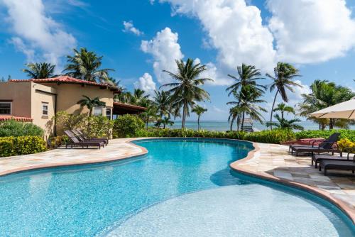 a swimming pool in front of a villa at Seascape Villas in San Pedro