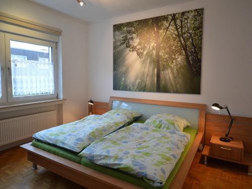 a bedroom with a bed and a painting on the wall at Ferienwohnung Schwebebahn in Wuppertal in Wuppertal