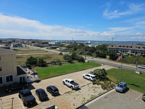 an aerial view of a parking lot with parked cars at Surf Side Hotel in Nags Head
