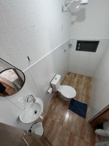 a bathroom with a toilet and a sink and a mirror at Pousada flor do sertão in Piranhas