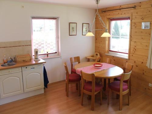 a kitchen and dining room with a table and chairs at Apartment in St Michael near Ski Slopes in Sankt Martin