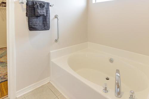 a white bath tub in a white bathroom at 3 Mi to Escambia Bay Home with Deck and Private Yard! in Milton