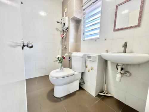 a white bathroom with a toilet and a sink at Semi D 16pax Landed Home WiFi Setia Alam Mall SCCC in Shah Alam