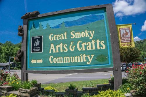 a sign for a great smoky arts and crafts community at Pinnacle Panorama by American Patriot Getaways in Rocky Grove