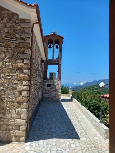 a gate to a building with a bell tower at Sunset in Rodhiná