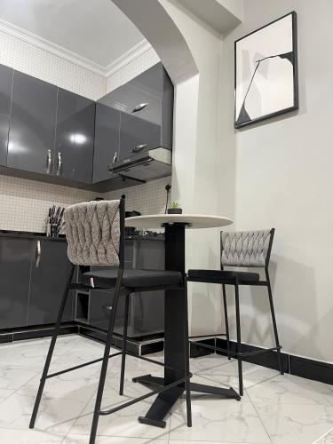 a table and two chairs in a kitchen at Chilly Stays - Mwamunyange in Dar es Salaam