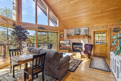a living room with a couch and a table and a fireplace at R & R Hideaway by American Patriot Getaways in Hornet