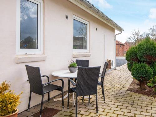 a table and chairs sitting on a patio at 4 person holiday home in Toftlund in Toftlund