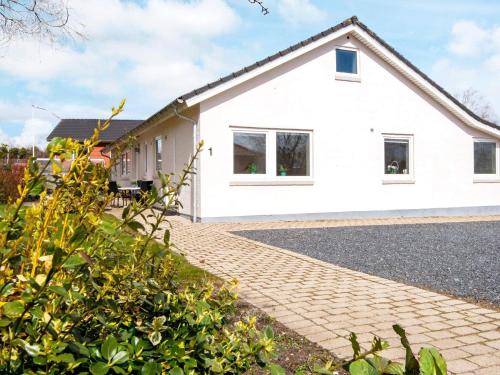 a white house with a brick driveway at 4 person holiday home in Toftlund in Toftlund