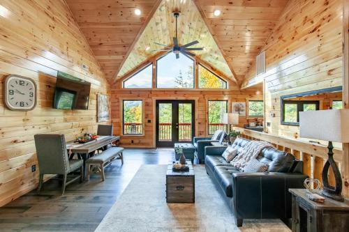 a living room with wooden walls and a large ceiling at Relaxing With a View by American Patriot Getaways in Glade