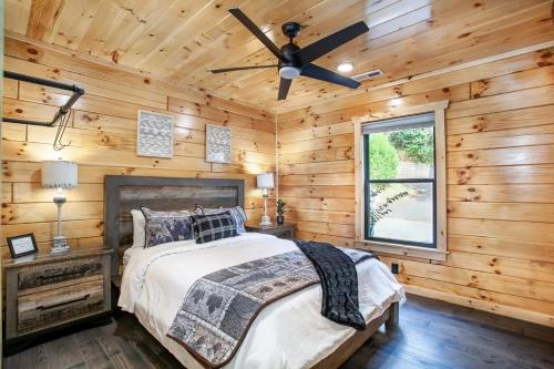 a bedroom with a bed and a ceiling fan at Relaxing With a View by American Patriot Getaways in Glade