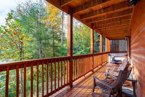 a porch with two chairs and a grill on it at Relaxing With a View by American Patriot Getaways in Glade