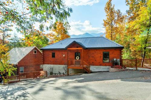 a log cabin with a fence in front of it at Relaxing With a View by American Patriot Getaways in Glade