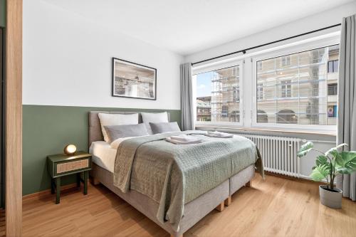 a bedroom with a bed and a large window at Apartment Pyramidenblick in Karlsruhe